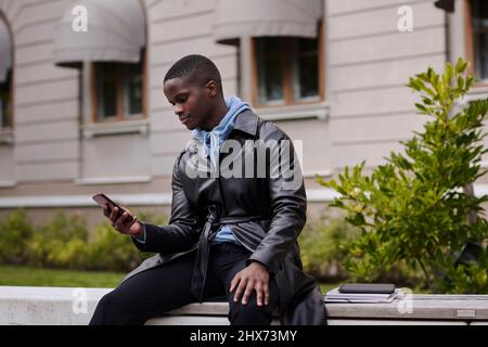 Young man using cell phone Stock Photo