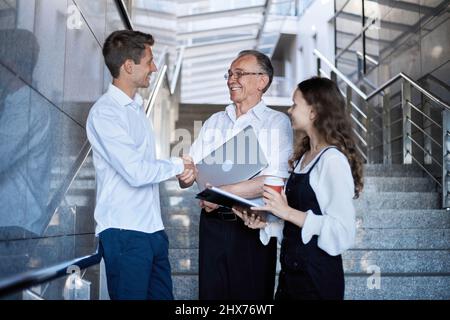 business people are talking standing on the stairs in the business center. Stock Photo