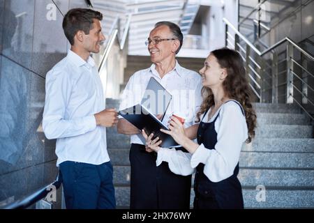 business people are talking standing on the stairs in the business center. Stock Photo
