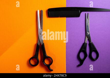 old hair clippers on a blue background with scissors and comb ,top view , copy space . Stock Photo