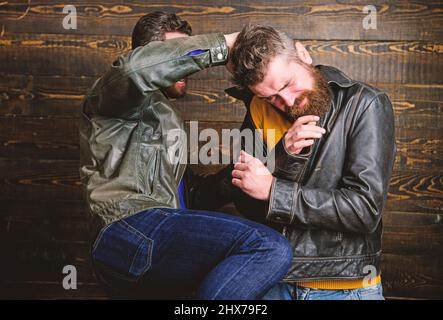 Men brutal hooligans wear leather jackets fighting. Physical attack. Men bearded hipster fighting. Attack and defence. Aggressive hooligan fighting Stock Photo