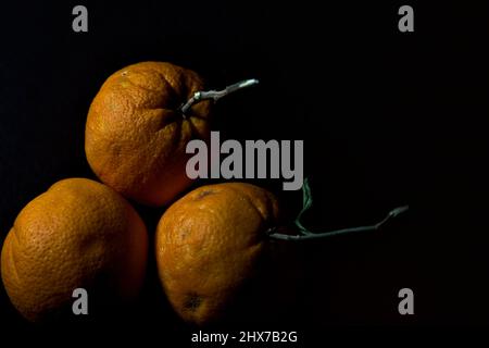 Three oranges on a black background Stock Photo