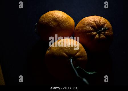 Three oranges on a black background Stock Photo