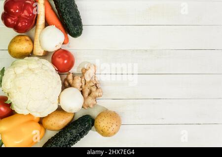 Raw pasta of various types and spices on a wooden table. View from above. Macaron on wooden table, space for text Stock Photo