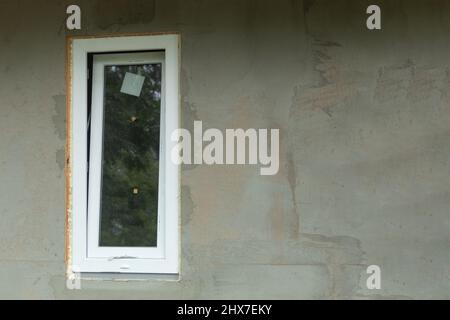 White metal-plastic window in a new building. Window installation process. Background with copy space Stock Photo