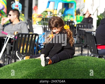 ASHKELON, ISRAEL - MARCH 04, 2022: little happy Israeli girl is playing outside. Stock Photo