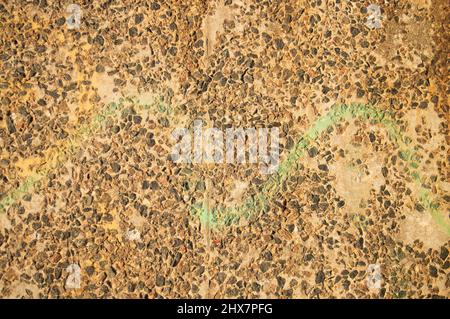 Bright stone background. Yellow and brown small stones shining in the sun Stock Photo