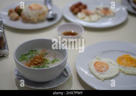 rice soup with fried eggs on the table Stock Photo
