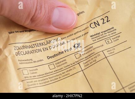 Tambov, Russian Federation - August 23, 2021 A woman holding envelope sent via Deutsche Post Stock Photo