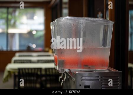 close up lever of juice dispenser for fresh orange juice. Stock Photo