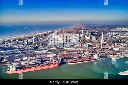 Netherlands, IJmuiden - 20-02-2022: Aerial view of heavy industry. Near the sea lock in the Noordzeekanaal. Stock Photo