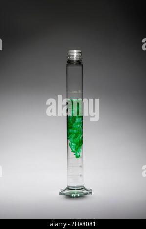 Tall thin beaker with green liquid, USA Stock Photo