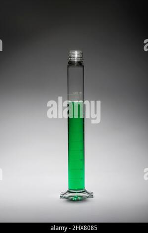 Tall thin beaker with green liquid, USA Stock Photo