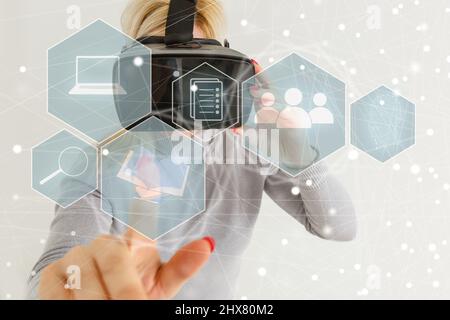 Young woman touch virtual hologram with non-fungible token hud, lines and art image icons. Glowing lines and blocks with nft symbol. Concept of Stock Photo