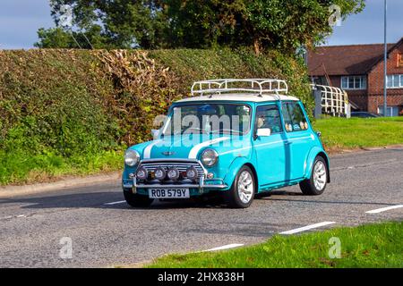 1999 90s nineties blue white Rover Mini Cooper 1275cc 2dr en-route to Capesthorne Hall classic August car show, Cheshire, UK Stock Photo