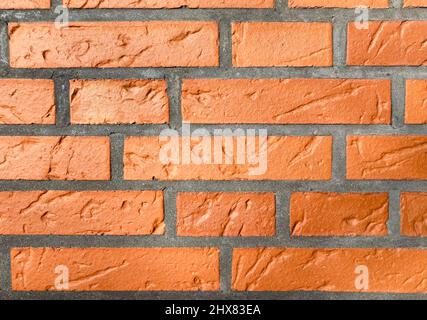 a reddish brown brick wall as background Stock Photo