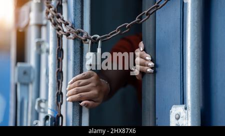 Woman trapped in cargo container wait for Human Trafficking or foreigh workers, Woman holding master key wait for holp help Stock Photo