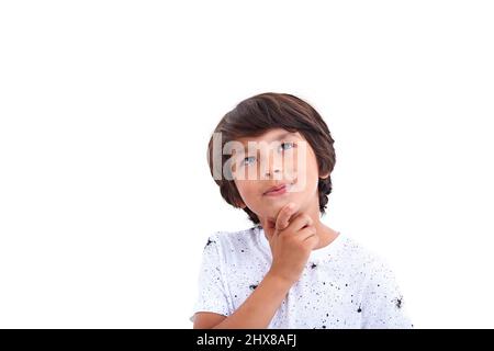 Boy think looking up, hold hand on chin Stock Photo