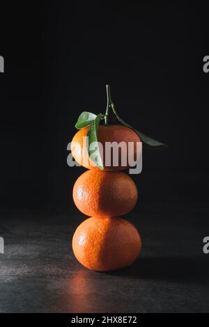 Fresh mandarin with leaves on dark background Stock Photo