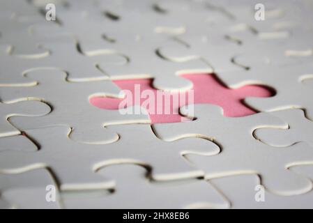 Image of white jigsaw puzzle with missing pieces. Incomplete, solution concept. Stock Photo