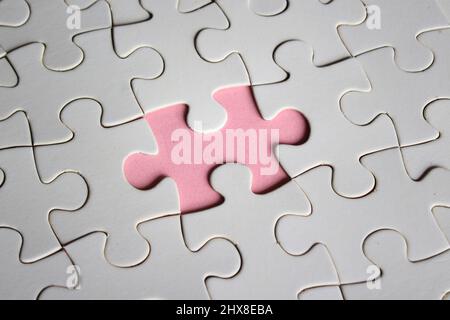 Image of white jigsaw puzzle with missing pieces. Incomplete, solution concept. Stock Photo