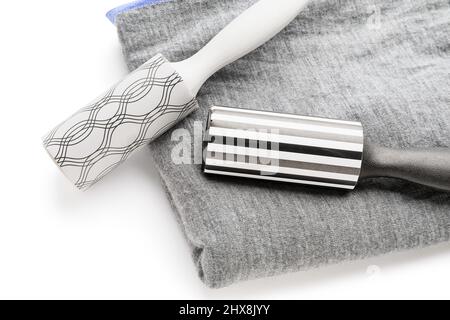 New lint rollers with clothes on white background Stock Photo