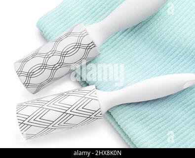 New lint rollers with clothes on white background Stock Photo