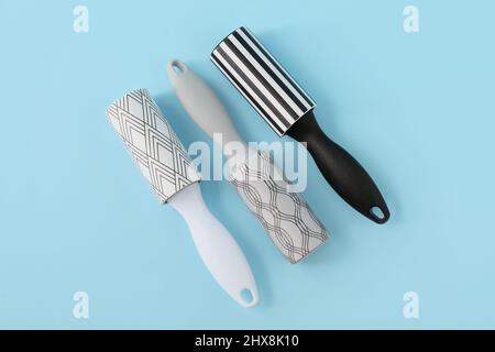 New lint rollers on blue background Stock Photo