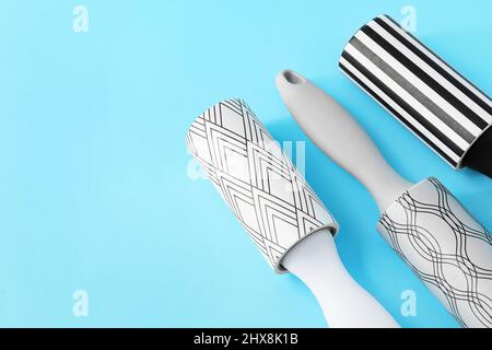 New lint rollers on blue background Stock Photo