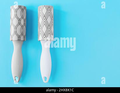 New lint rollers on blue background Stock Photo
