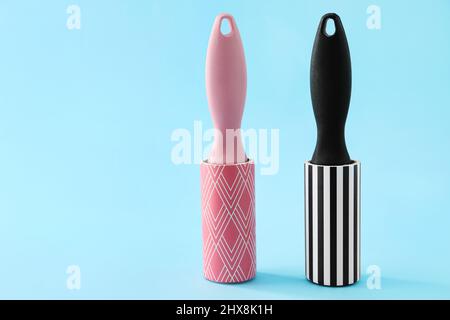 New lint rollers on blue background Stock Photo