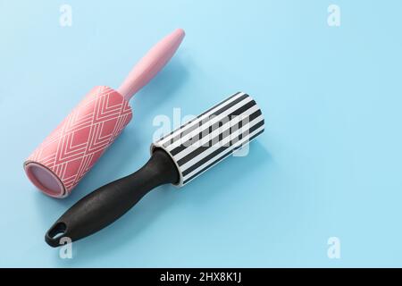 New lint rollers on blue background Stock Photo
