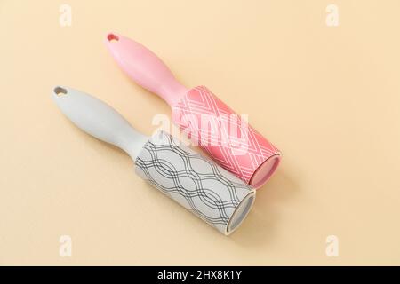 New lint rollers on beige background Stock Photo