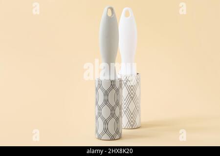 New lint rollers on beige background Stock Photo