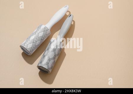 New lint rollers on beige background Stock Photo