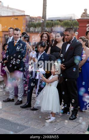 Mexico, Guanajuato, San Miguel de Allende,   young girl at wedding blowing bubbles with a bubble gun Stock Photo
