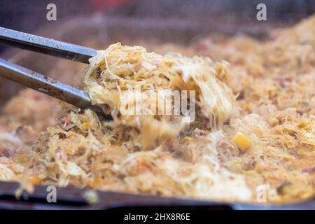 Roasted fresh white cabbage offered on the market. Stock Photo