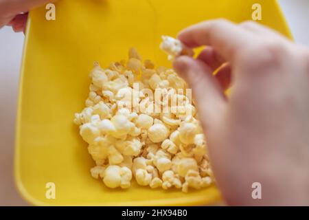 A bucket of popcorn, top-view, warm colors, daylight macro close-up, good time Stock Photo
