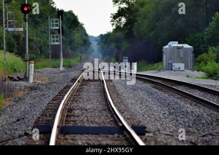 Hoffman Estates, Illinois, USA. A  passing siding merges into a single track mainline that disappears into the distant background. Stock Photo