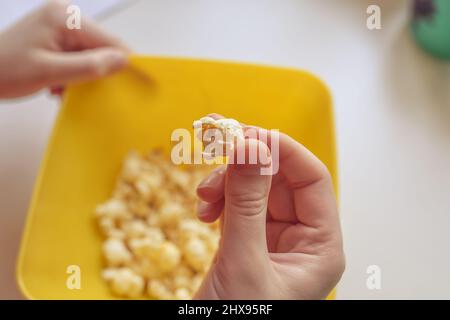 A bucket of popcorn, top-view, warm colors, daylight macro close-up, good time Stock Photo