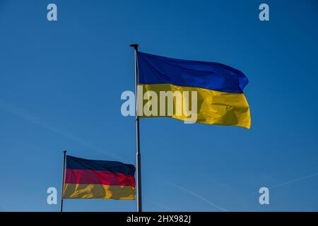 A German, Ukrainian and European flag wave in front of the Reichstag ...