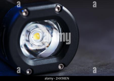 Black Rechargeable Flashlight handheld, LED close-up on a black background Stock Photo