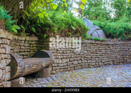 Wooden bench made of logs in the park. Stock Photo