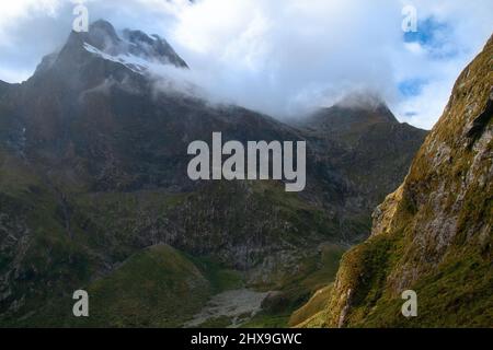 Mighty mountains in fog Mount Elliot, Jervois Glacier and Mt Wilmur, Milford Track New Zealand Stock Photo