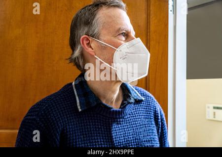 Man wearing Protective Face Mask, head and shoulders Profile Stock Photo