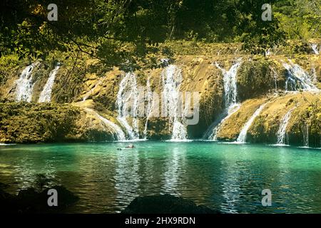 Tourist enjoying the beautiful pools of Semuc Champey, Rio Cabohon, Lanquin, Alta Verapaz, Guatemala Stock Photo