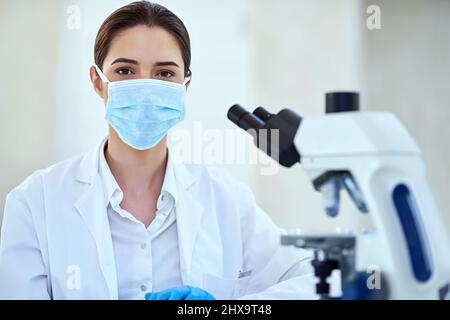 I might have found the next scientific breakthrough. Shot of a female scientist working alone in the lab. Stock Photo
