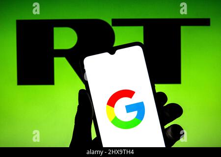 Spain. 9th Mar, 2022. In this photo illustration a Google logo seen displayed on a smartphone with a RT logo in the background. (Credit Image: © Thiago Prudencio/SOPA Images via ZUMA Press Wire) Stock Photo