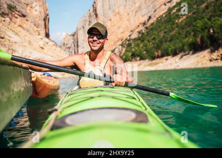 Happy man in his kayak ready to go on a canyon route. Stock Photo
