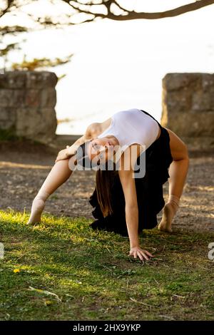 Teenage Female Dance Doing Backbend in the Park Stock Photo